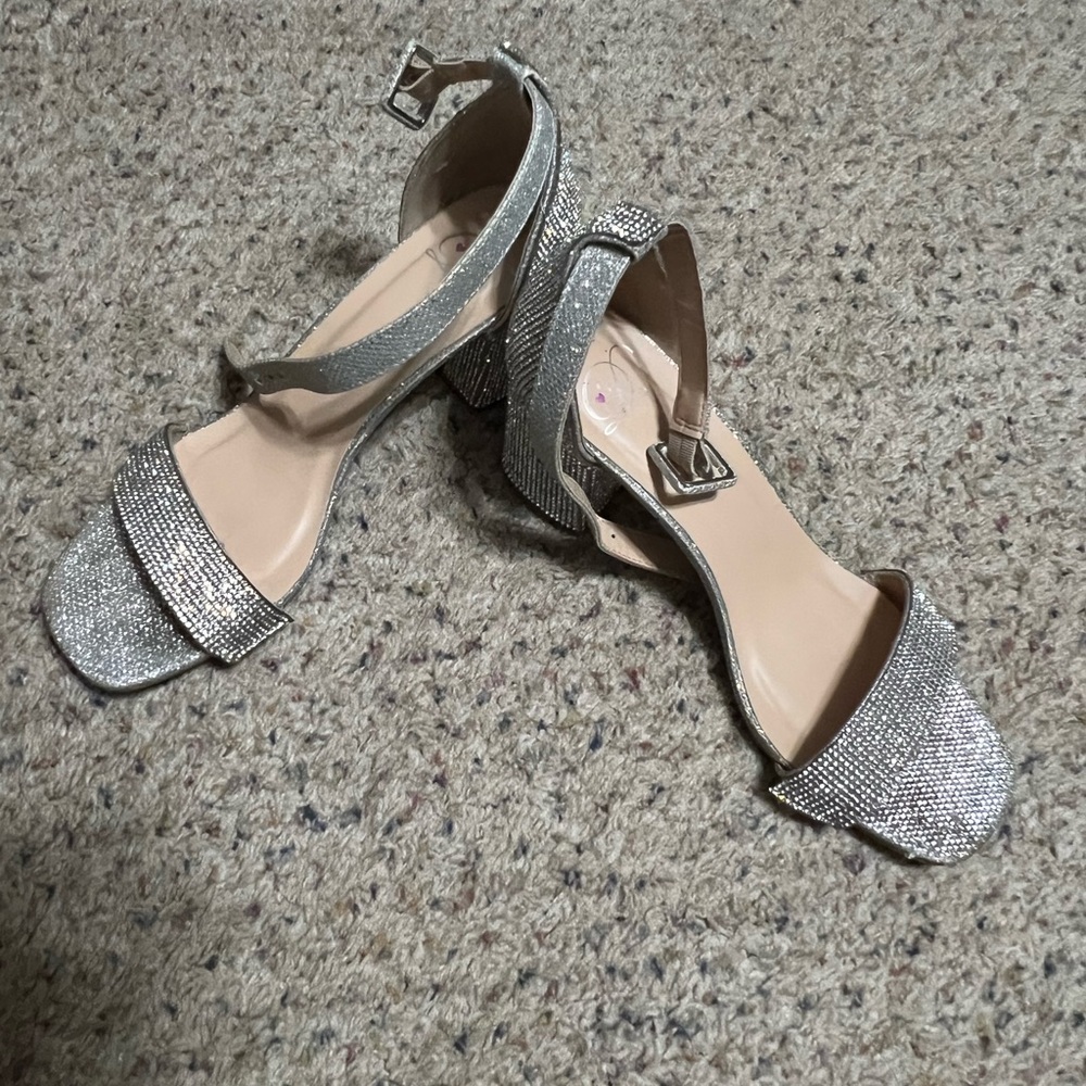 Women’s silver shimmer special occasion buckle sandal.
